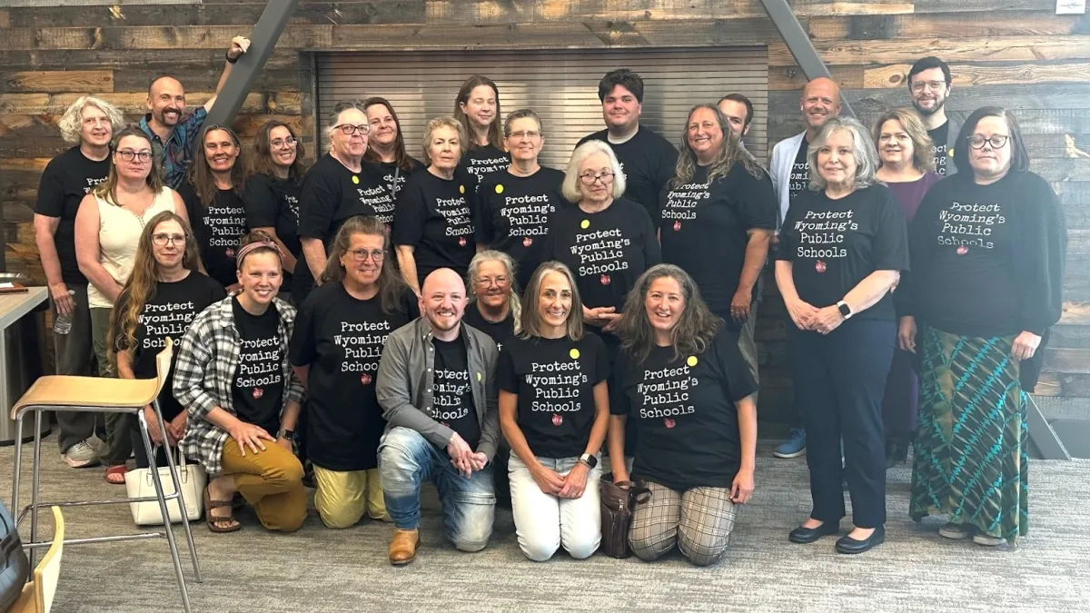 WEA members and advocates gather while wearing Protect Wyoming's Public Schools shirts