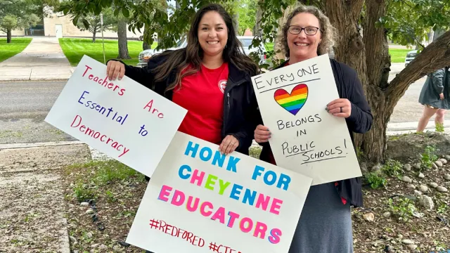 Educators with signs at the Cheyenne rally in 2025