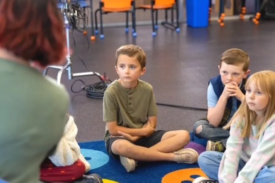 students sitting on a carpet for storytime